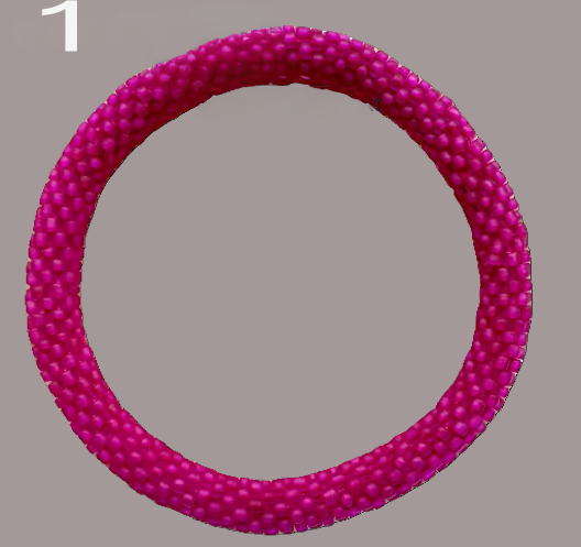 A selection of beaded bracelets in shades of pink, handmade from Nepal.