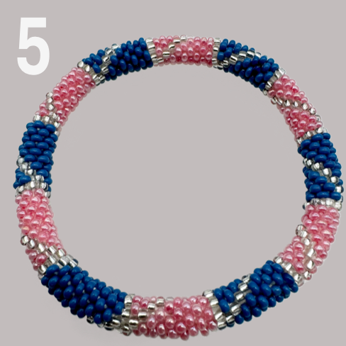 A selection of beaded bracelets in shades of pink, handmade from Nepal.